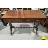 A Georgian style crossbanded mahogany sofa table with 2 frieze drawers, on splay feet with brass