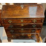 A Georgian crosshanded and inlaid fall front bureau with graduating drawers under, on bracket