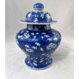 A Chinese covered baluster jar in blue and white prunus blossom, height 26 cm