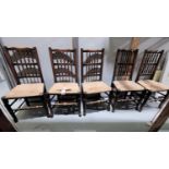 A 19th century set of 6 country made elm dining chairs with spindle backs and rush seats (some