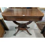 A Regency period crossbanded rosewood card table with fold-over rounded rectangular top, baize lined