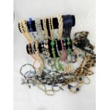 A large selection of decorative bead and other costume necklaces from the mid 20th century