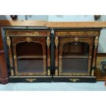 A 19th century pair of red boule and and contra boule ebonised pier cabinets, with ormolu mounts,