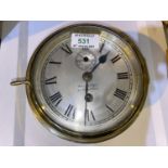 A ships clock in cylindrical brass case, with silvered dial, by Wm Jenkins, Dumbarton, diameter 18