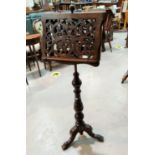 A 19th century fretwork adjustable double sided music stand, on turned baluster column and triple