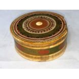 A Japanese ivory circular lidded box with fine decoration and inlay in gilt green and red,