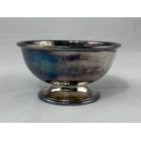 A small circular hallmarked silver bowl on raised foot, Sheffield 1977, 3.3oz. (103gm)