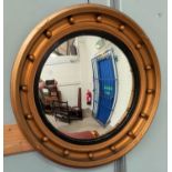 A large convex wall mirror in gilt ball frame