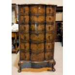 A late 19th/early 20th century burr walnut 6 height chest of drawers in the Queen Anne style with