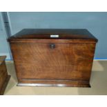 An early 20th century oak stationery cabinet with out-folding writing slope, fitted interior with