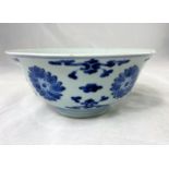 A Chinese blue and white bowl with flared rim bearing seal mark to base, decorated with flowers