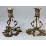 A mid 20th century pair of Irish silver candlesticks in the rococo style, having scrolled supports