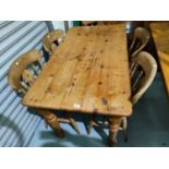 A pine kitchen table with rectangular top and 4 beech chairs with fiddle backs