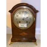 An Edwardian dwarf bracket clock in inlaid mahogany arch top case, with silvered dial and French