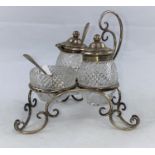 A silver and cut glass cruet stand of scalloped openwork form, with matched spoons, maker L&S,