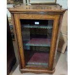 A Victorian crossbanded figured walnut music cabinet with brass gallery and glazed door