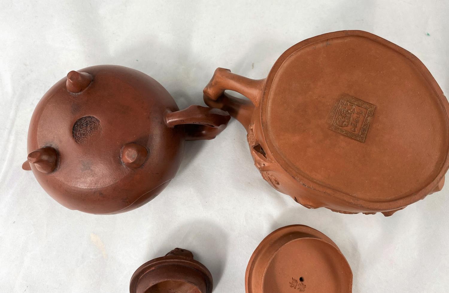 Two Yixing tea pots both with seal marks, 1 with character mark decoration, 1 with relief decoration - Image 4 of 4