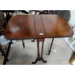 An Edwardian inlaid mahogany Sutherland table of slender proportions, on turned legs and castors