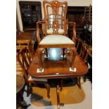 A reproduction Regency yew wood dining suite the table with rectangular extending top on twin