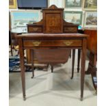 An Edwardian inlaid rose wood small bonheur du jour in the Sheraton style, with raised cupboard