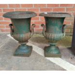A pair of cast iron garden urns in the classical style with antique green finish
