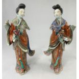A pair of finely decorated ceramic Chinese women in traditional clothing, height 30cm, both a.f.