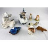 A Royal Copenhagen figure of a seated Amish girl and a group of 2 fighting polar bears; 3 Beswick