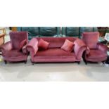 An early 20th century drop arm three seater settee, covered in pink draylon velvet and a pair of