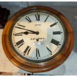 A late 19th/early 20th century wall clock with circular dial, in stained wood case, timepiece