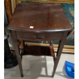 An Edwardian mahogany occasional table with oval drop leaf top and frieze drawer, on square tapering