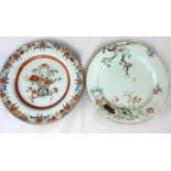 A Chinese porcelain plate with polychrome floral decoration, diamter 23cm; another similar plate