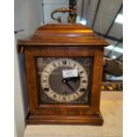A reproduction 18th century style bracket clock in walnut caddy top case, brass dial and chiming