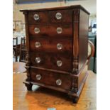 A 19th century mahogany miniature chest of 4 long and 2 short drawers with glass knob handles,