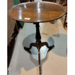 An 18th century oak occasional table with dish top, on turned baluster column and triple splay feet,