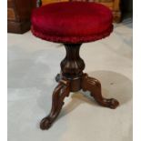 A Victorian walnut piano stool with revolving burgundy seat, on triple scrolled legs; a 19th century