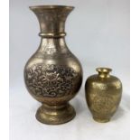 An oriental brass vase with floral relief panel, height 33cm and another smaller oriental vase