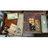 A Victorian folding backgammon board, leather covered, with a set of boxwood discs; a selection of