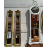 A pair of bevelled edge wall mirrors in gilt frames with bow finials, height 122 cm; a full length