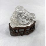 A Chinese rock crystal carving of a seated buddha on wooden base, height 3.5cm, height on base 7cm