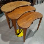 A nest of three mid century teak designer pebble shaped occasional tables