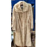 A blonde full length fur coat, medium