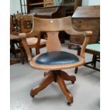 An early 20th century oak office swivel armchair