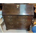 An 18th century oak country made bureau with fall front, fitted and stepped interior, 3 long and 2