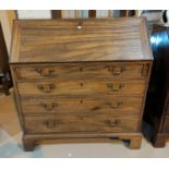 A Georgian mahogany fall front bureau with fitted interior and 4 long graduating drawers, on bracket