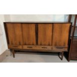 A 1960's Danish rosewood high sideboard, with shelves enclosed by 4 sliding doors and 3 drawers