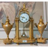 A Louis XVI clock garniture in ormolu and yellow marble, the clock with 4 columns, floral enamel