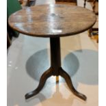 An 18th century country made occasional table with circular top on plain turned column and 3 splay