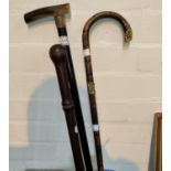 A 19th century ebony walking stick; a similar bamboo cane; a constabulary nightstick