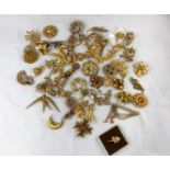 A selection of gilt costume jewellery, mainly brooches