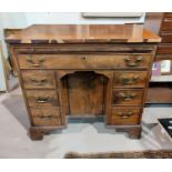 A late 19th/early 20th century mahogany bachelors desk, with brushing slide, frieze drawer, 6